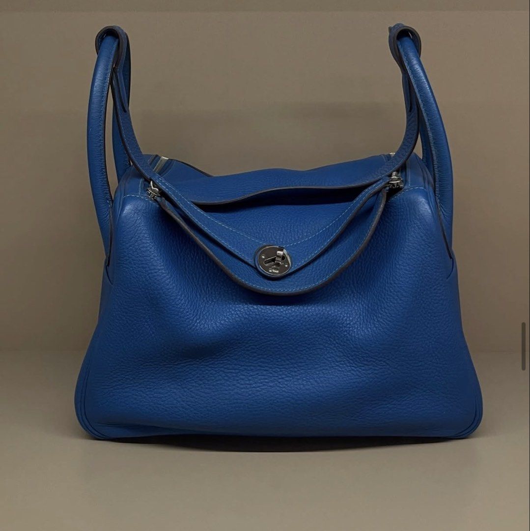 Hermes Lindy 30 mykonos (Category: Luxury Bags & Wallets) located in Makati City. Submitted by dgcurated09 (Listing ID 1469568247, Image 1). Description: - Brand: Hermes Lindy - Color: Bright blue - Material: Supple leather with silver-tone hardware - Closure: Fold-over flap with turn-lock clasp and top zipper - Handles: Dual rolled top handles - Base: Structured with protective feet - Interior: Generous and slouchy capacity - Condition: Excellen