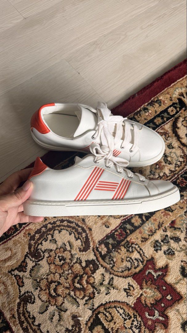 Hermès Quicker Sneaker White Orange Size 36 (Category: Sneakers) located in Paranaque City. Submitted by patrickkyl48122 (Listing ID 1469499655, Image 2). Description: Bought sa hermes greenbelt Srp 53k Selling for 20k nalang No inclusion 100% authentic 2x used only - Brand: Hermès - Model: Quicker Low-Top Sneakers - Size: 36 (stamped inside) - Color: White calfskin with iconic orange 'H' stripes and vibrant orange heel counters - Origin: Made in