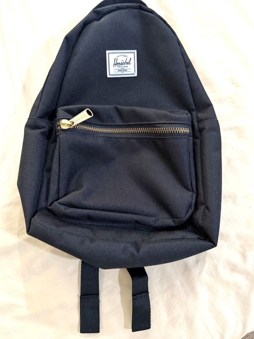 Herschel Classic Mini Backpack, Black (Lightly Used) (Category: Backpacks) located in Makati City. Submitted by cheenaroonie (Listing ID 1469422116, Image 1). Description: Black Herschel mini backpack, lightly used and still in excellent condition. • Front zip pocket with gold zipper and engraved Herschel pull • Main zip compartment with striped lining and an inside slip pocket • Adjustable shoulder straps + top grab loop • Small and light, good 