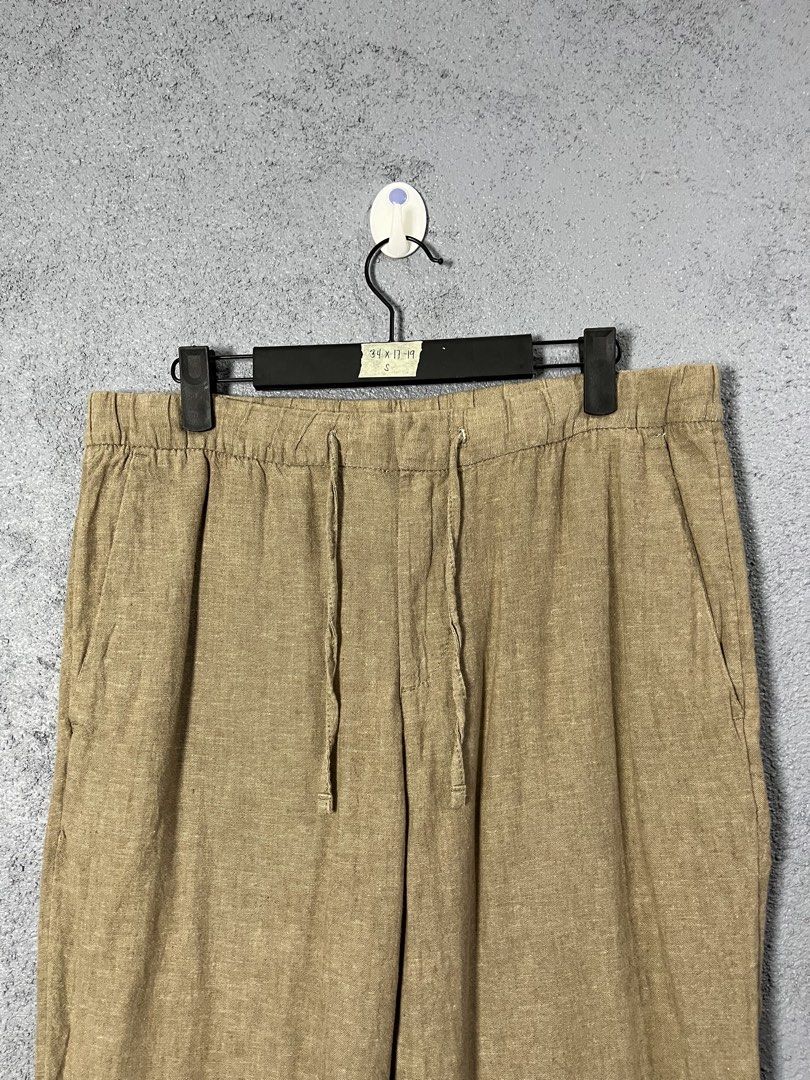 H&M Beige Linen Cotton Drawstring Pants Size S (Category: Trousers) located in Famy. Submitted by basicthrifted (Listing ID 1469404601, Image 2). Description: - Color: Versatile beige - Material: Breathable 55% linen and 45% cotton blend - Fit: Relaxed fit with an elastic waistband and adjustable drawstring - Features: Convenient side pockets - Origin: Made in Bangladesh - Style Tip: Great for pairing with casual shirts in warm weather.