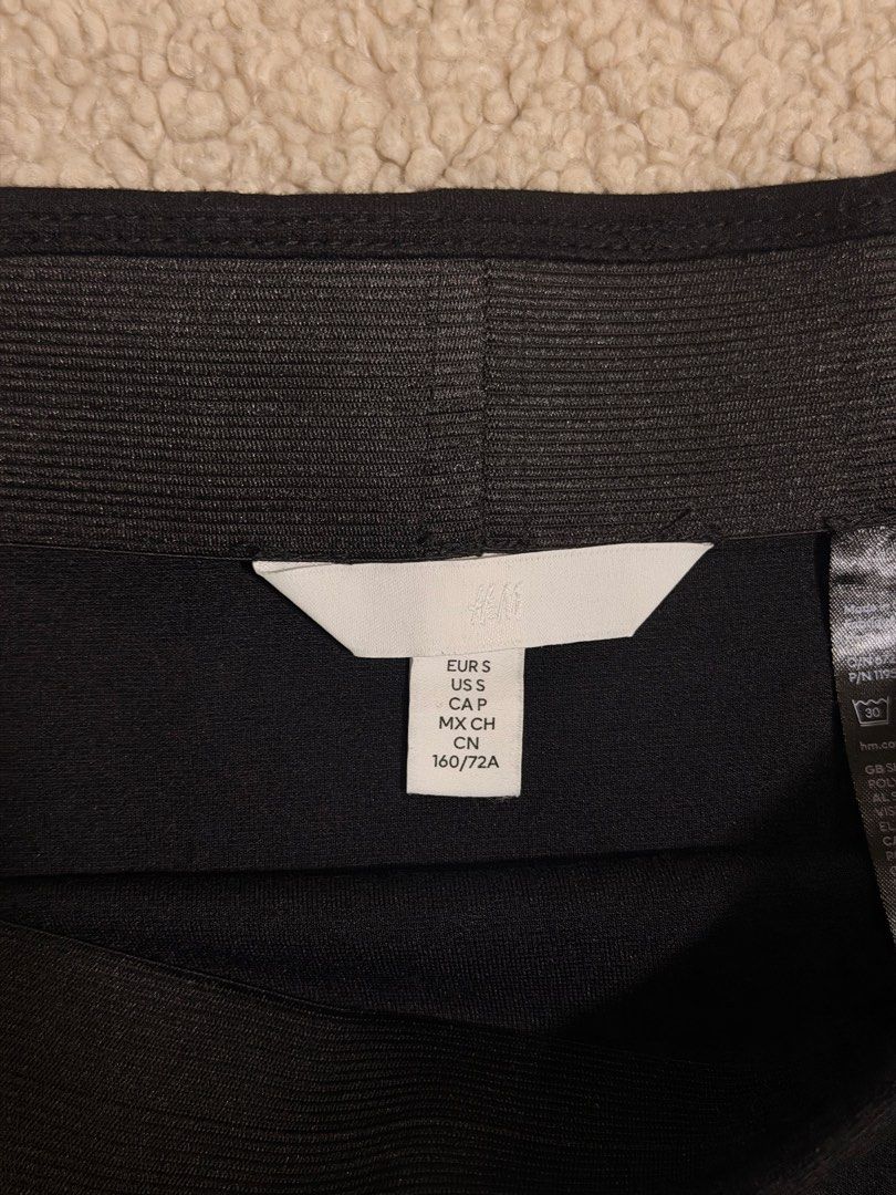 H&M Black Mini Skirt Size S (Category: Skirts) located in Las Pinas. Submitted by ann.co. (Listing ID 1469544167, Image 3). Description: - Brand: H&M - Style: Black skirt with chic front slit detail - Size: S (fits true to standard sizing) - Waistband: Stretchy elastic for easy and comfortable wear - Condition: Clean fabric, no stains, and no damage - Styling: Versatile piece, easy to pair with basic tees or crop tops.