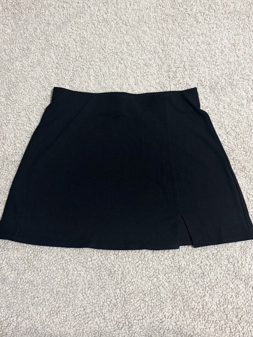 H&M Black Mini Skirt Size S (Category: Skirts) located in Las Pinas. Submitted by ann.co. (Listing ID 1469544167, Image 1). Description: - Brand: H&M - Style: Black skirt with chic front slit detail - Size: S (fits true to standard sizing) - Waistband: Stretchy elastic for easy and comfortable wear - Condition: Clean fabric, no stains, and no damage - Styling: Versatile piece, easy to pair with basic tees or crop tops.