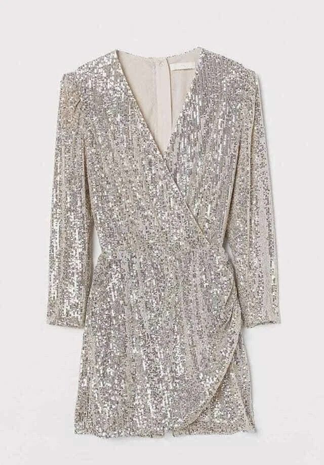 H&M Gold/Silver Sequin Wrap Playsuit (Category: Rompers) located in Quezon City. Submitted by gilliesshoppe (Listing ID 1469566279, Image 1). Description: - Style: Silver sequin playsuit with long sleeves and crossover wrap front. Zipper enclosure at the back. It somewhat has a gold reflection because of the nude base of the sequin cloth. (Check last photo for color comparison) - Size 42 (best fits large to xl size) - Details: V-neckline, gathere