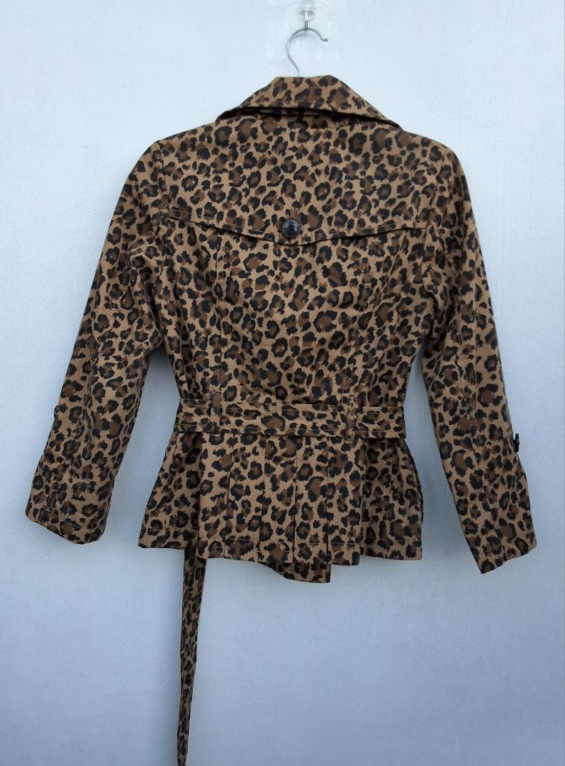 H&M Leopard Print Trench Jacket (Category: Coats, Jackets and Outerwear) located in Makati City. Submitted by justget8 (Listing ID 1469529555, Image 2). Description: - Brand: H&M - Size: 34 (UK 6 / XS) - Style: Leopard print trench coat - Details: Notched lapels, black buttons, matching waist belt with rectangular buckle - Back: Pleated back detail with a button flap.