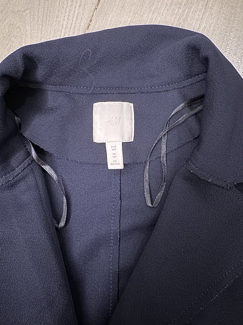 H&M Navy Blue Trench Coat Size 40P (Category: Coats, Jackets and Outerwear) located in Taguig. Submitted by sqaumejada (Listing ID 1469414248, Image 2). Description: - Brand: H&M - Color: Dark Blue - Size: EUR 40P / US 8P / UK 12P / CN 160/92A (Petite fit) - Design: Simple lapel collar, long sleeves, and two front pockets - Material: 95% polyester, 5% elastane (Shell); 100% polyester (Pocket lining) - Care: Machine washable at 40 degrees - Condit