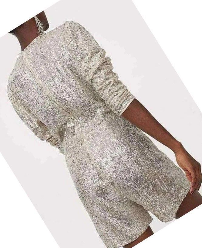 H&M Gold/Silver Sequin Wrap Playsuit (Category: Rompers) located in Quezon City. Submitted by gilliesshoppe (Listing ID 1469566279, Image 2). Description: - Style: Silver sequin playsuit with long sleeves and crossover wrap front. Zipper enclosure at the back. It somewhat has a gold reflection because of the nude base of the sequin cloth. (Check last photo for color comparison) - Size 42 (best fits large to xl size) - Details: V-neckline, gathere