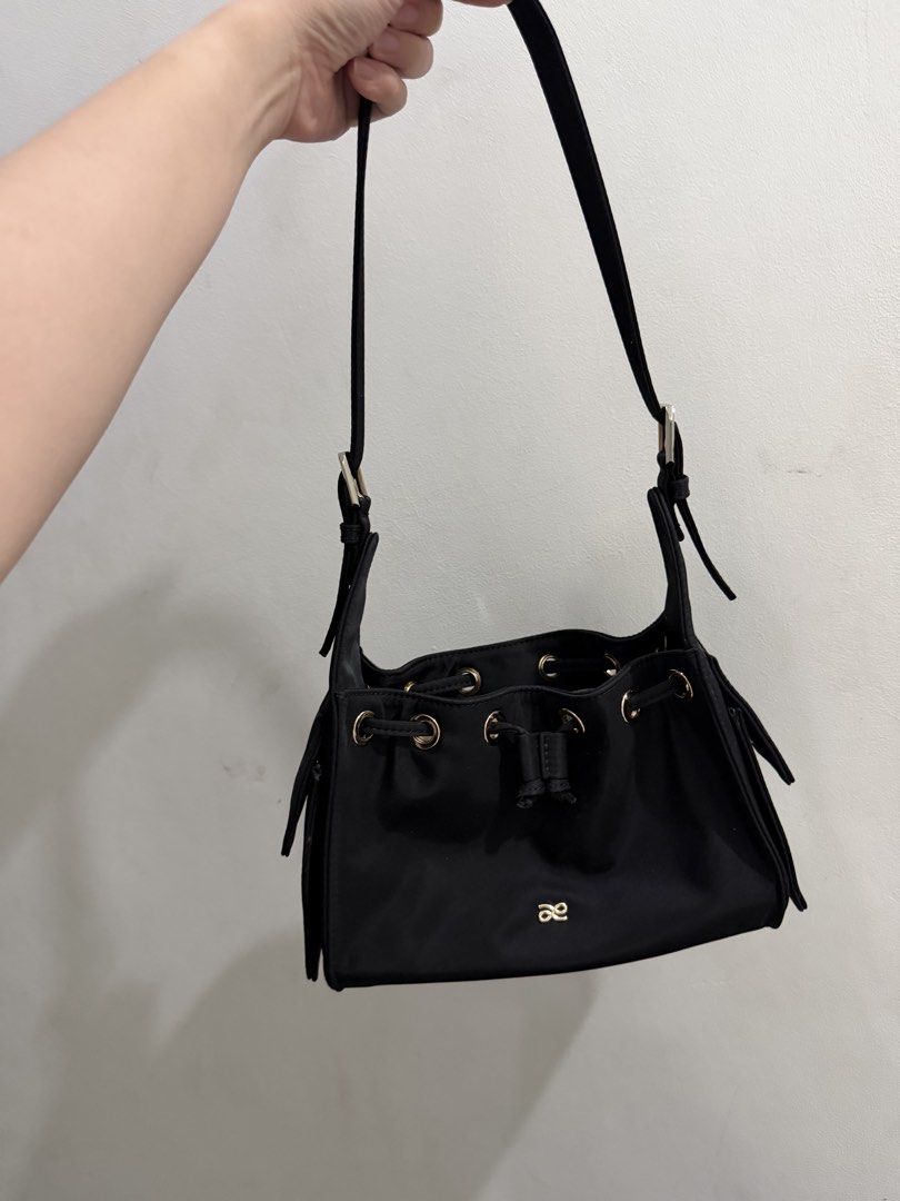 HOLB Yumi Nylon Bond Small (Category: Luxury Bags & Wallets) located in Quezon City. Submitted by shop.withnikki (Listing ID 1469496015, Image 2). Description: inclusions: dust bag and 2 straps - Color: black - Material: Durable nylon with gold-tone hardware and grommets - Closure: Secure drawstring top - Strap: Adjustable shoulder strap for comfortable wear - Interior: Beige fabric lining with a convenient slip pocket - Capacity: Perfect size to