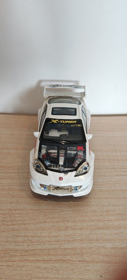 Honda Integra Type R Custom Diecast Model Car (Category: Vehicle & Diecast Models) located in Manila. Submitted by wilbert.lua (Listing ID 1469485524, Image 3). Description: - Custom white Honda Integra Type R collectible toy car - Eye-catching Mugen and X-Tuner graphics - Features opening doors and detailed engine under hood and rear glass - Styled with a rear spoiler, gold wheels, and striking blue interior seats - Must-have piece for JDM enthu