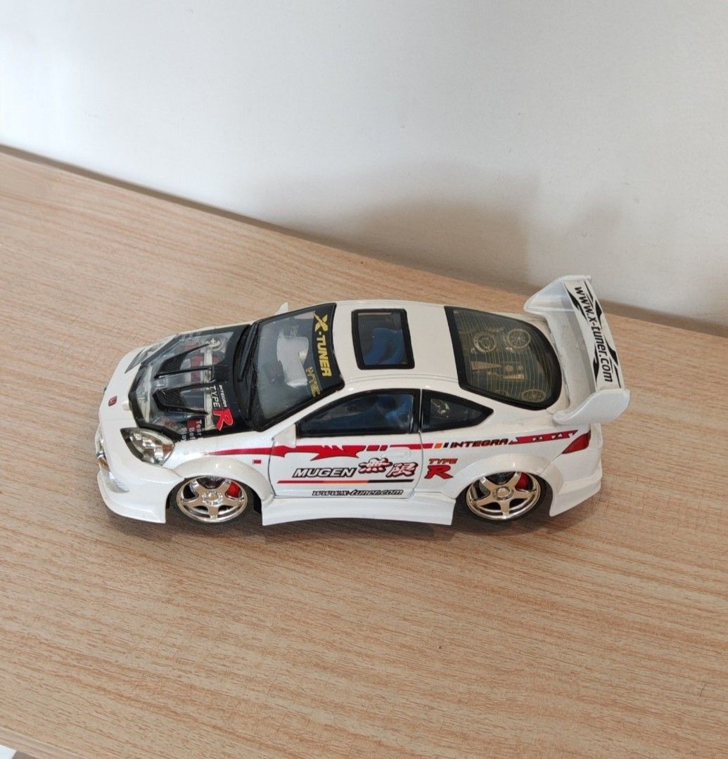 Honda Integra Type R Custom Diecast Model Car (Category: Vehicle & Diecast Models) located in Manila. Submitted by wilbert.lua (Listing ID 1469485524, Image 1). Description: - Custom white Honda Integra Type R collectible toy car - Eye-catching Mugen and X-Tuner graphics - Features opening doors and detailed engine under hood and rear glass - Styled with a rear spoiler, gold wheels, and striking blue interior seats - Must-have piece for JDM enthu