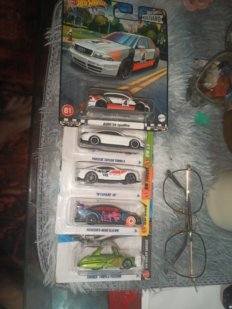 Hot Wheels Diecast Car Bundle Set (Category: Vehicle & Diecast Models) located in Manila. Submitted by junjunortega09 (Listing ID 1469566834, Image 1). Description: - Bundle of 5 Hot Wheels diecast cars - Includes: Audi S4 quattro, Porsche Taycan Turbo S, '18 Camaro SS, Mercedes-Benz CLA HW, Tooned Purple Passion - Condition: Brand new, original unopened packaging - Note: Packaging has standard shelf wear - Ideal for collectors wanting multiple m