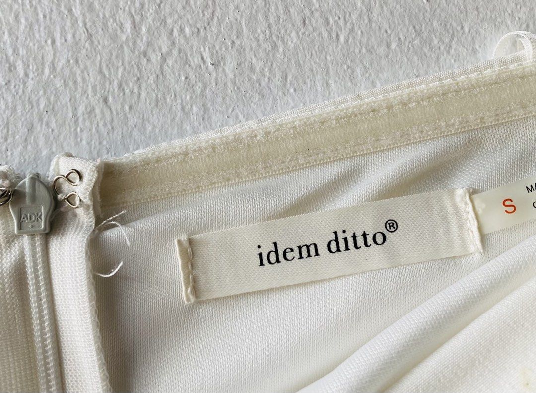 Idem Ditto White Strapless Ruffle Romper (Category: Rompers) located in Caloocan City. Submitted by lovemyclothes21 (Listing ID 1469463466, Image 3). Description: - Brand/Style: White romper from Idem Ditto - Size: Small - Design: Strapless neckline with structured bodice seams and double-layered ruffle skirt overlaying shorts - Closure: Side zipper with hook and eye fastening - Extra Feature: Anti-slip grip strip along the inner top edge for sec