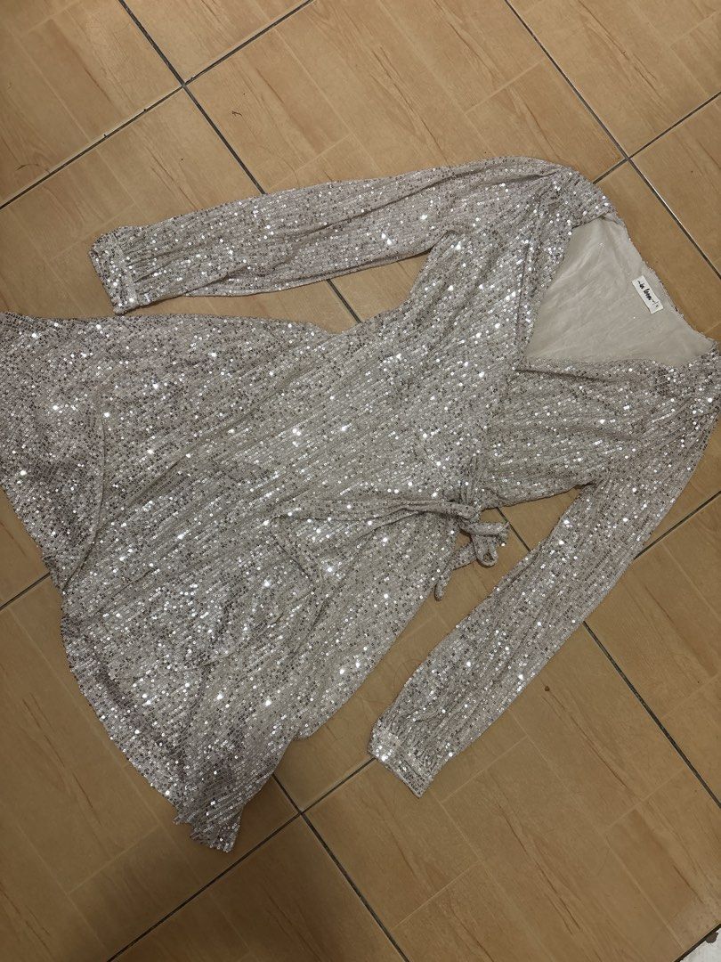 In Loom Silver Sequin Wrap Dress Long Sleeve (Category: Dresses) located in Cabuyao City. Submitted by airpz (Listing ID 1469433744, Image 3). Description: - Brand: In Loom - Style: Silver sequin wrap dress with V-neckline and self-tie waist - Details: Long sleeves with button cuffs, fully lined, short length - Perfect for: Parties, dinners, and night outs.
