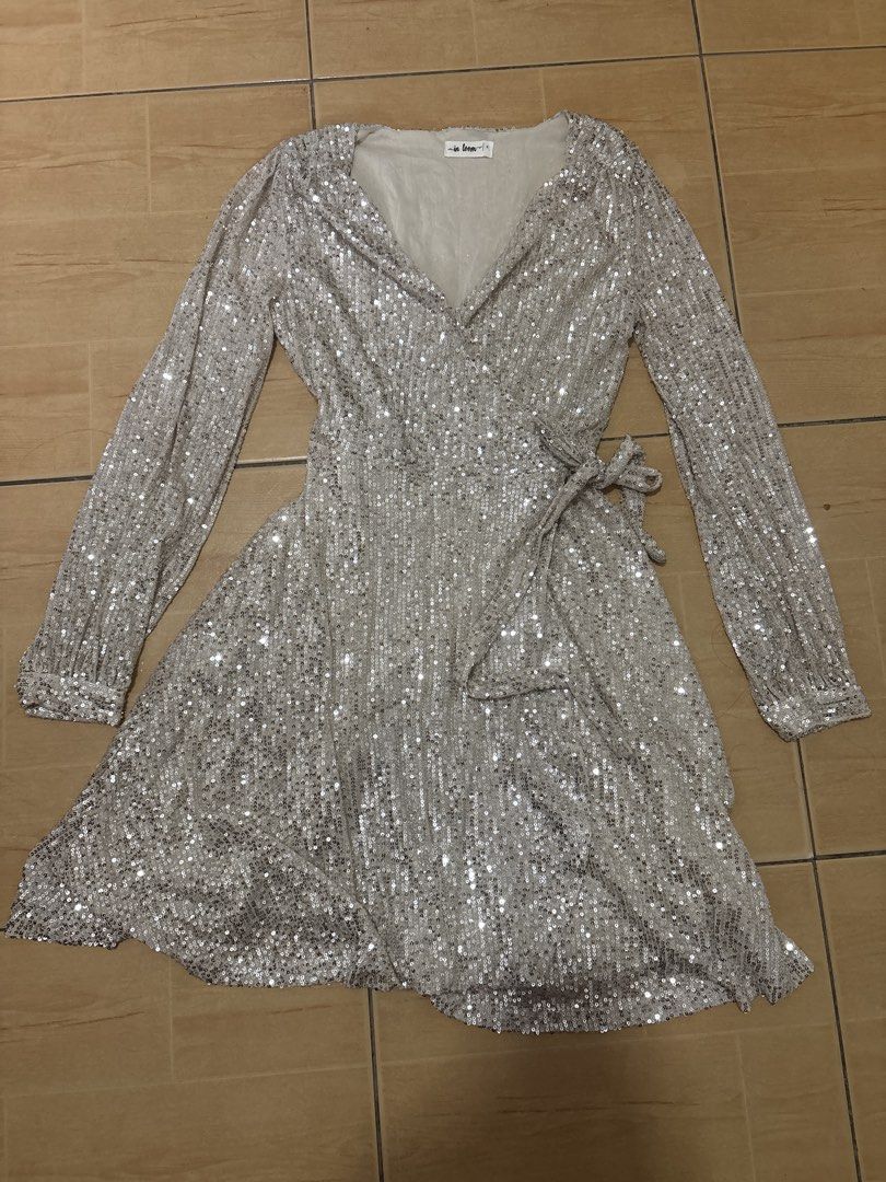In Loom Silver Sequin Wrap Dress Long Sleeve (Category: Dresses) located in Cabuyao City. Submitted by airpz (Listing ID 1469433744, Image 1). Description: - Brand: In Loom - Style: Silver sequin wrap dress with V-neckline and self-tie waist - Details: Long sleeves with button cuffs, fully lined, short length - Perfect for: Parties, dinners, and night outs.
