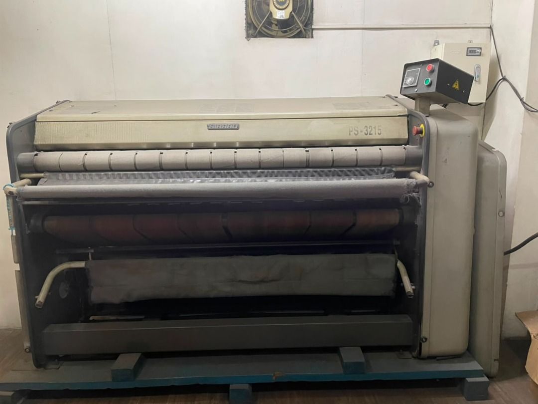 Industrial Girbau Flatworks (Category: Industrial Equipment) located in Caloocan City. Submitted by a.foty.888 (Listing ID 1469403564, Image 1). Description: - Industrial Flatworks - Heavy-duty laundry machine with built-in control panel and rollers - Mounted on a sturdy metal frame - Industrial grey finish with signs of normal commercial use - Powers up via standard control box - Note: Heavy equipment, requires proper transport and setup.