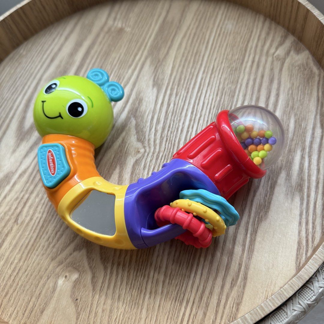 Infantino Sensory Caterpillar Rattle Teether Toy (Category: Infant Playtime) located in Marikina City. Submitted by lovegoeson (Listing ID 1469426571, Image 2). Description: - Brand: Infantino - Item: Caterpillar baby rattle - Condition: Clean and well-maintained - Features bright multicolour segments with different textures - Includes spinning rings and a baby-safe mirror - Tail end features a clear dome filled with colorful rattling beads - Eas