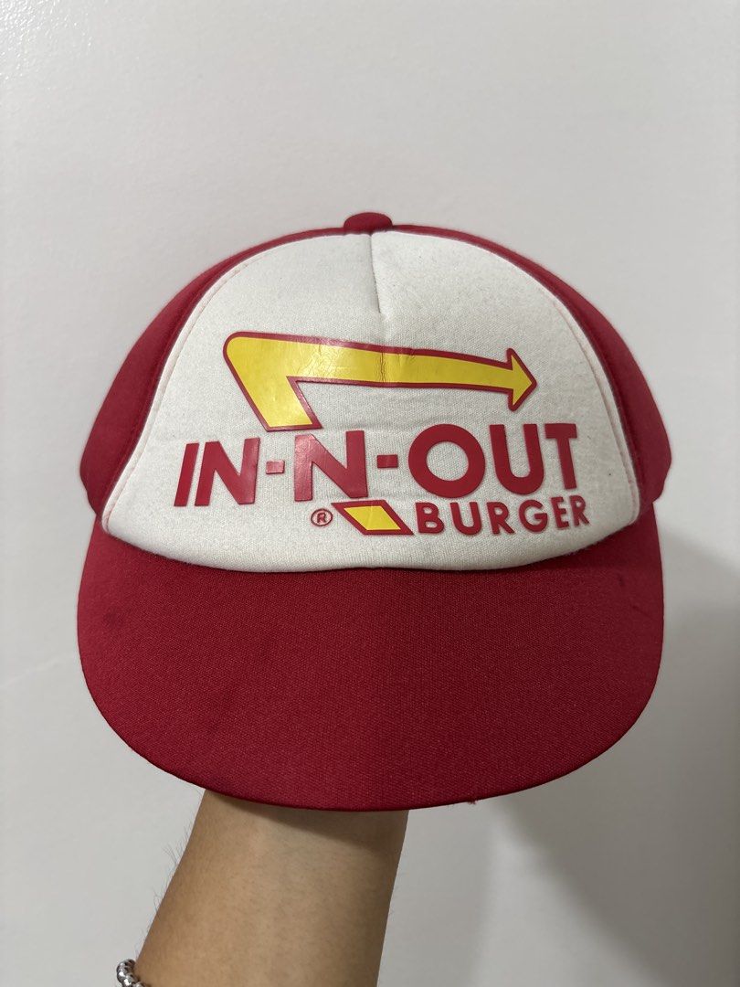 In-N-Out Burger Red White Snapback Trucker Hat (Category: Caps & Hats) located in Calbayog City. Submitted by zaxcheus_castillo1708 (Listing ID 1469509632, Image 1). Description: - Brand: In-N-Out Burger - Style: Snapback hat (red and white colorway) - Details: Raised rubberized logo on front, yellow inner mesh lining - Closure: Adjustable plastic strap at the back - Condition: Clean, brand new with tag still attached.