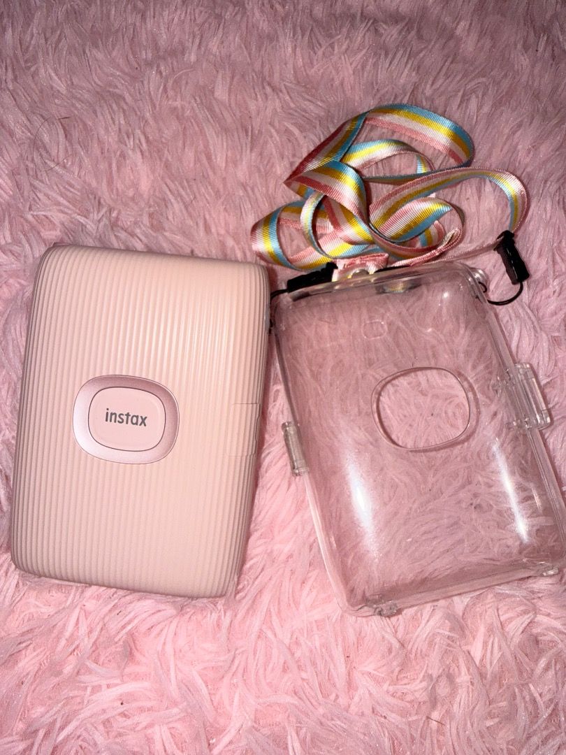 INSTAX MINI LINK 2! (Category: Other Gadgets) located in Caloocan City. Submitted by reynyyy184 (Listing ID 1469492710, Image 2). Description: ✨Fujifilm Instax Mini Link 2 with Protective Case✨ Price: ₱4,500 (Slightly negotiable) Description: Selling my pre-loved Fujifilm Instax Mini Link 2 Smartphone Printer. Perfect for printing your phone photos instantly. PACKAGE INCLUSIONS: • 1 x Instax Mini Link 2 Unit (Color: Pink) • 1 x Protective Case (w