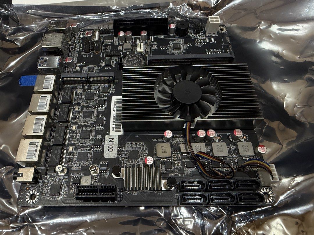 Intel N100 NAS Motherboard with Quad LAN (Category: Desktops) located in Roxas City. Submitted by keso.12 (Listing ID 1469499350, Image 3). Description: - Processor: Built-in Intel N100 CPU - Cooling: Includes active cooler fan attached to heatsink - Network: 4x Quad Ethernet ports on rear I/O - Storage: Multiple SATA ports for hard drives and SSDs - Connectivity: USB ports and audio jack included - Extras: Comes with original I/O shield plate - 