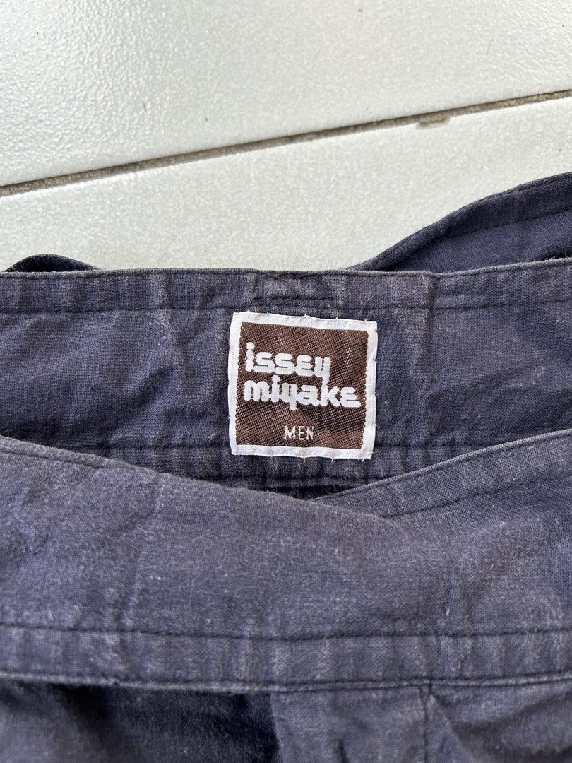 Issey Miyake Men Belted (Category: Trousers) located in Angeles City. Submitted by cassey_phoenix (Listing ID 1469469323, Image 2). Description: - Brand: Issey Miyake Men (LG44558) - Color: burgundy - Size: Medium (M) - Material: 100% Cotton (Made in Japan) - Fit: Straight wide leg cut with pleated front - Features: Integrated waist tie belt - Manufacturer: Issey Miyake International - Condition: Pristine, ready to wear.