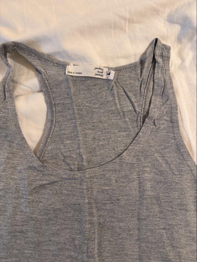 Jackey and Jamie Grey Racerback Tank Top (Category: Sleeveless) located in Quezon City. Submitted by ianne.declutter (Listing ID 1469437310, Image 2). Description: - Brand: Jackey and Jamie - Size: Large - Color: Grey - Material: Lightweight cotton-blend (soft and breathable) - Design: Racerback, scoop neckline, sleeveless - Origin: Made in Thailand - Condition: Basic wardrobe essential, great for layering or solo wear.