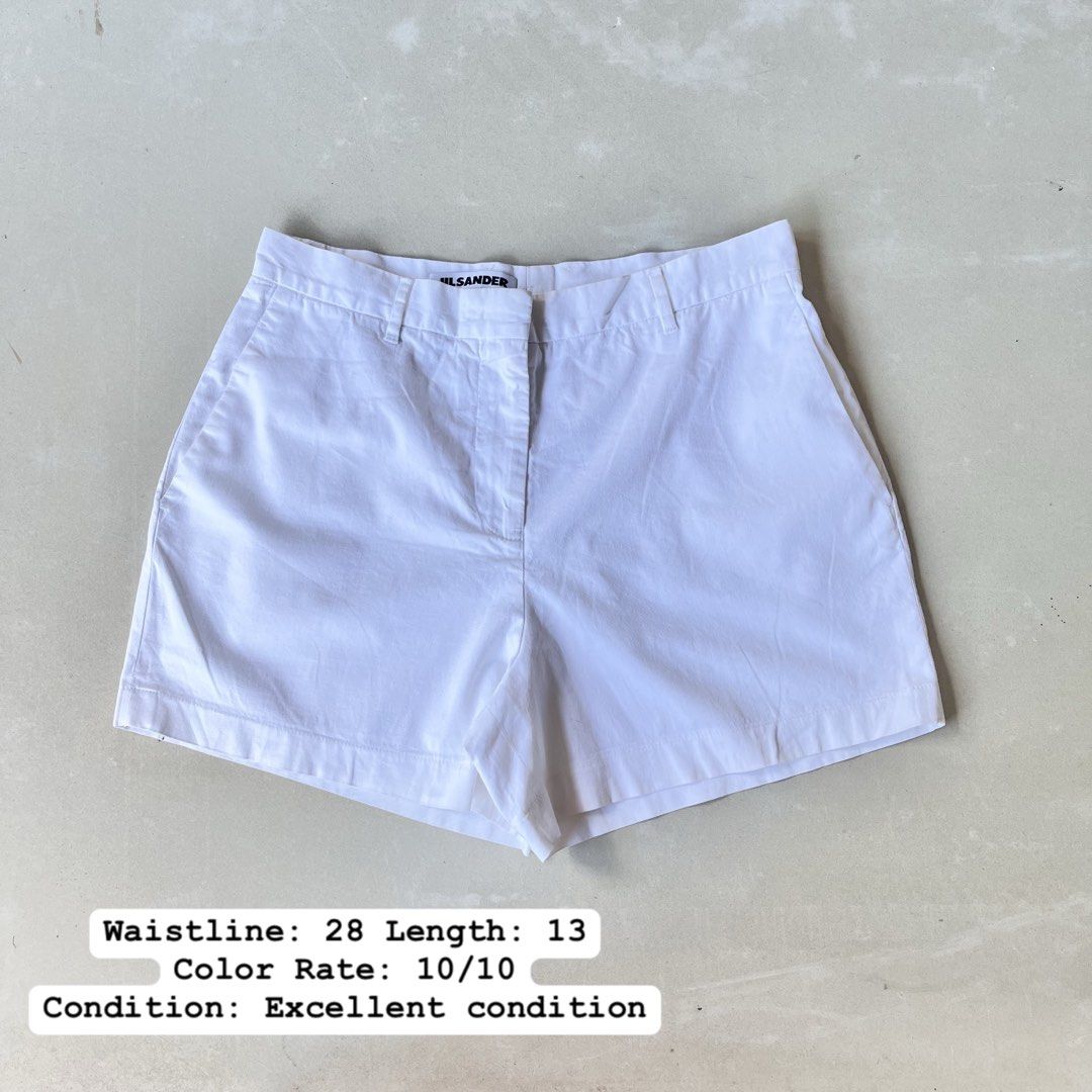Jil Sander White Shorts (Category: Shorts) located in Mandaue City. Submitted by chinsyap_03 (Listing ID 1469468216, Image 1). Description: - Brand: Jil Sander - Color: Solid White - Material: Crisp cotton - Style: Minimalist cut with zip fly, button closure, and belt loops - Pockets: Front pockets and single buttoned back pocket - Measurements: Waist 28 inches, Length 13 inches - Condition: Excellent overall shape, very clean fabric.