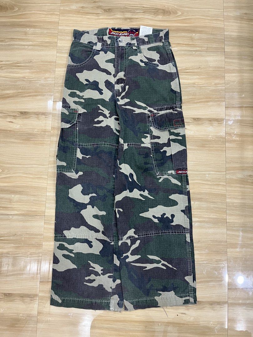 JNCO Jeans Camouflage Cargo Pants (Category: Jeans) located in Angeles City. Submitted by thriftsij (Listing ID 1469542613, Image 2). Description: -JNCO CARGO CAMOFLAUGE -5500 Free Shipping Obo -W28L38T11LO9 - Design: Green camouflage print with classic cargo style - Details: Multiple side pockets, utility loops, and iconic embroidered crown logo on the back pocket - Branding: Red woven JNCO labels on the side and waistband interior - Origin: Ass