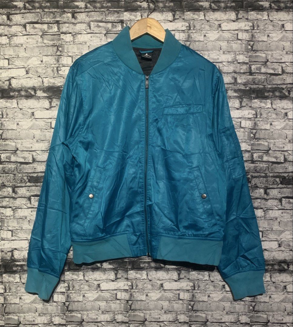 Jordan Blue Bomber Jacket (Category: Coats, Jackets and Outerwear) located in Manila. Submitted by marksaban81396 (Listing ID 1469549214, Image 2). Description: Size large Width 21 Lenght 27 Color rate 9 No issue excellent concc F- Brand: Jordan - Color: Teal blue - Closure: Full zip front - Details: Ribbed collar, cuffs, and hem - Pockets: Front snap-button pockets plus a left sleeve utility pocket - Interior: Dark lining with Jordan branding - 