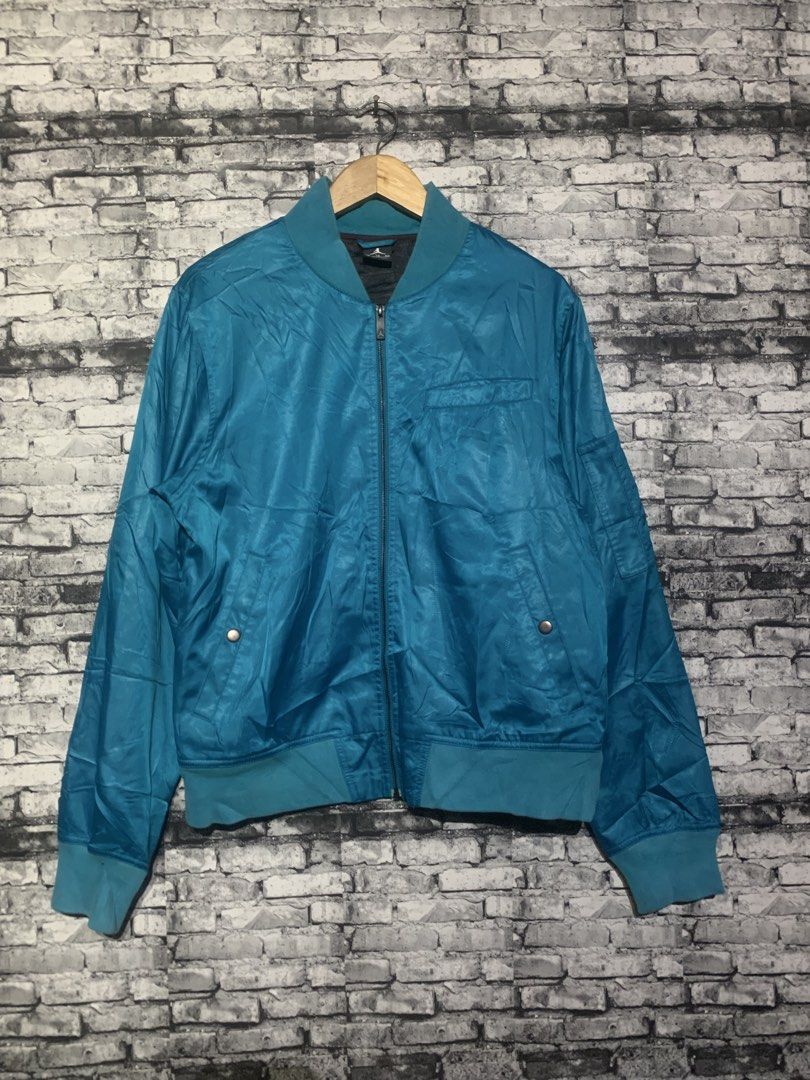 Jordan Blue Bomber Jacket (Category: Coats, Jackets and Outerwear) located in Manila. Submitted by marksaban81396 (Listing ID 1469549214, Image 1). Description: Size large Width 21 Lenght 27 Color rate 9 No issue excellent concc F- Brand: Jordan - Color: Teal blue - Closure: Full zip front - Details: Ribbed collar, cuffs, and hem - Pockets: Front snap-button pockets plus a left sleeve utility pocket - Interior: Dark lining with Jordan branding - 