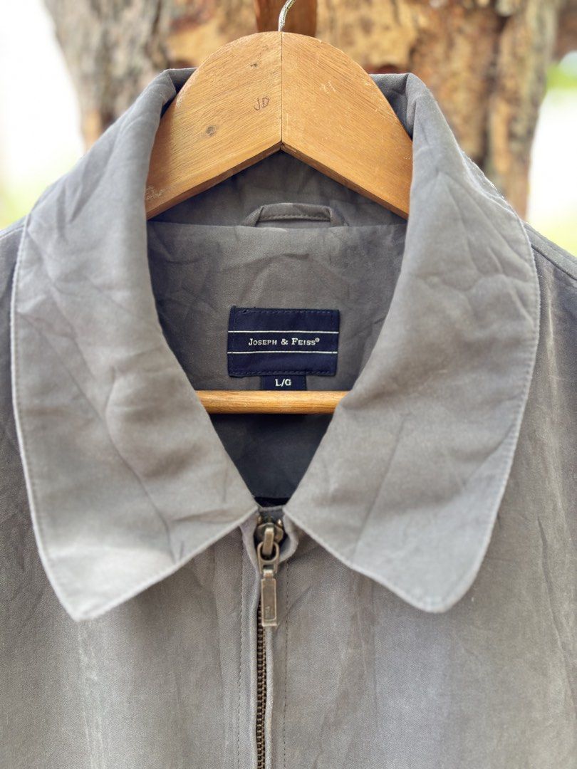 Joseph & Feiss Gray Zip Up Jacket Size L (Category: Coats, Jackets and Outerwear) located in San Jacinto. Submitted by ticao_thrift (Listing ID 1469571739, Image 3). Description: - Brand: Joseph & Feiss - Color: Gray - Size: L/G - Design: Classic collared zip-up jacket with full metal zipper closure - Features: Front pockets, elastic hem, and smooth inner lining with branded tape detail - Condition: Excellent, ready to wear.