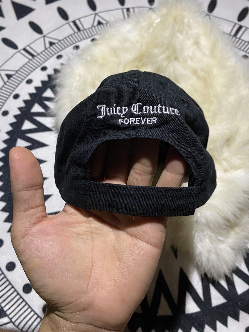 Juicy Couture Black Juicy Forever Cap (Category: Caps & Hats) located in Badiangan. Submitted by iralorana.thrift (Listing ID 1469419222, Image 3). Description: - Brand: Juicy Couture - Color: Classic black with white embroidery - Details: 'Juicy' script on front, 'Juicy Couture FOREVER' on the back - Size: One size fits most (approx. 56 cm circumference) - Material: 100% cotton with fabric care tag inside - Fit: Adjustable strap closure in back 