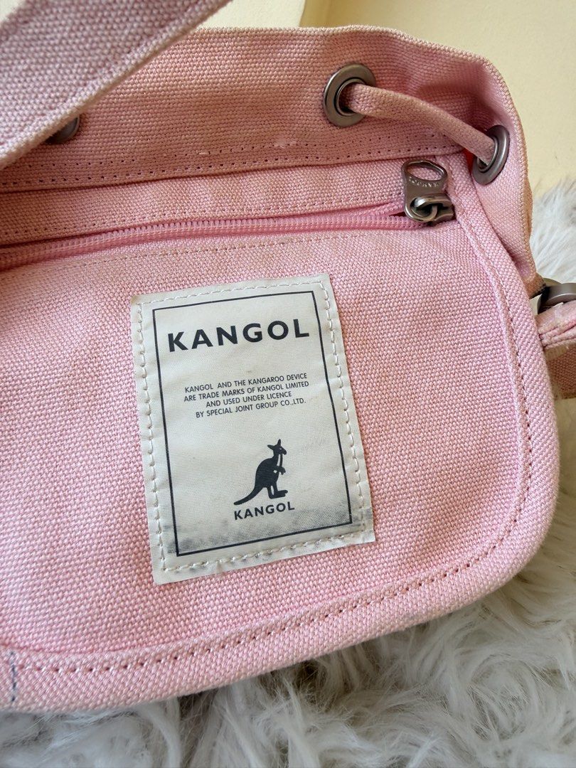 Kangol Pink Canvas Bucket Bag (Category: Shoulder Bags) located in Solano. Submitted by hayami. (Listing ID 1469436736, Image 3). Description: - Brand: Kangol - Color: Pink - Material: Durable canvas - Closure: Drawstring top - Pockets: Handy front pocket with logo patch, plus an internal zipper compartment for small items - Carrying Options: Dual top handles and a detachable shoulder strap - Condition: Light staining on the internal fabric patch