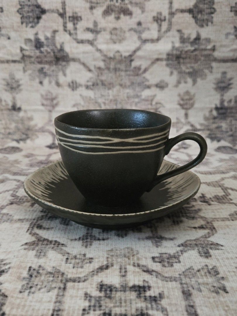 Kansai cup and saucer set (Category: Coffee & Tea Tableware) located in Manila. Submitted by cwknds (Listing ID 1469469726, Image 1). Description: a moody, earthy set with a matte black finish, subtle hand-painted stripes, and a beautifully textured saucer. • cup: 7 x 8.3 cm • saucer: 13.5 cm • brandnew - personally sourced&curated.