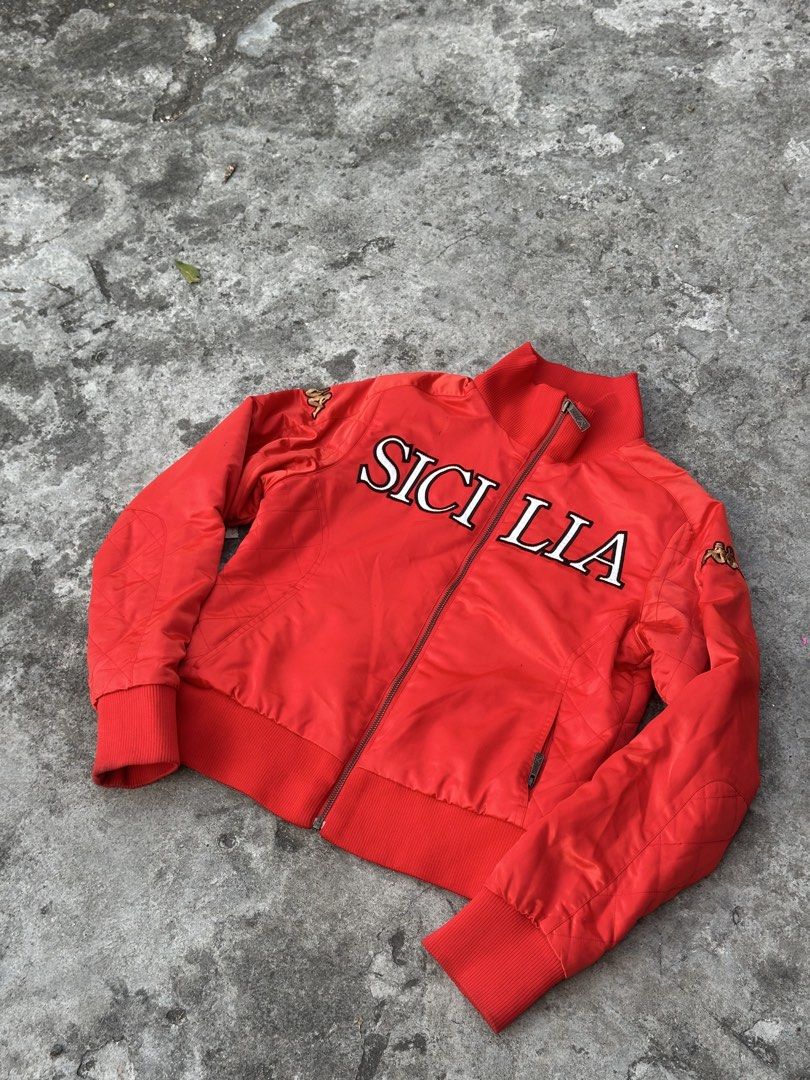 Kappa Sicilia Red Bomber Jacket (Category: Coats, Jackets and Outerwear) located in Bago City. Submitted by thekasproject (Listing ID 1469477151, Image 2). Description: - Color: Bright red - Size: Medium - Design: Sicilia lettering across the chest with quilted detailing on sleeves and sides - Branding: Embroidered Kappa logo patches on shoulders and back collar - Features: Full-zip front closure with ribbed collar, cuffs, and hem - Condition: Ex