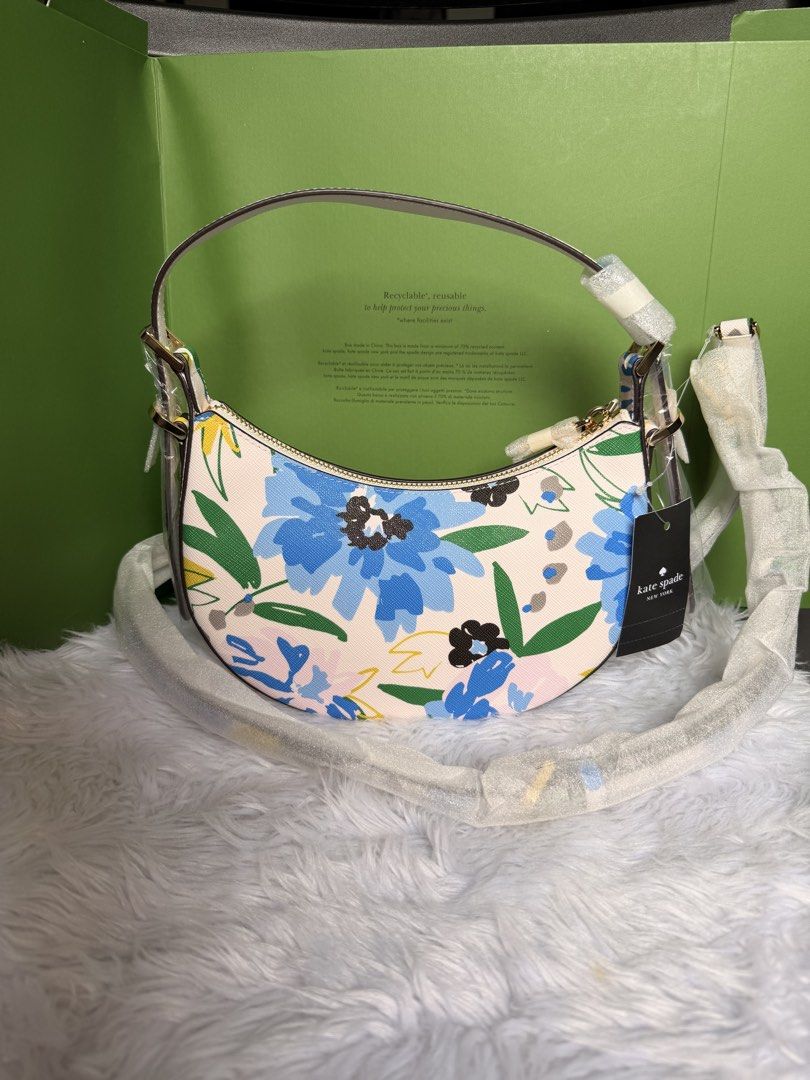 Kate Spade Floral Crescent Shoulder Bag (Category: Shoulder Bags) located in Rizal. Submitted by gannda (Listing ID 1469440625, Image 2). Description: - Brand: Kate Spade - Condition: Brand new with tags (never used) - Design: Blue & yellow floral pattern on off-white - Style: Curved crescent shoulder bag - Hardware: Gold-tone - Closure: Top zip - Strap: Includes detachable & adjustable matching strap for crossbody wear - with paper bag or box.