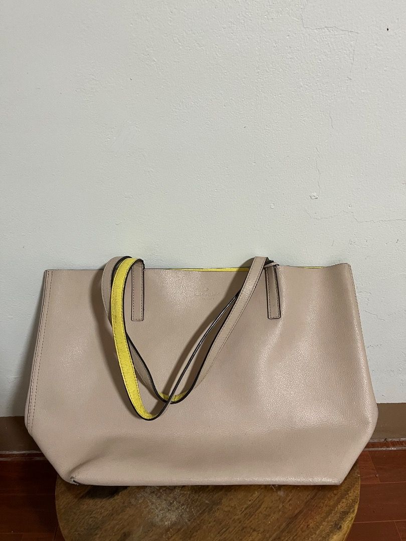 Kate Spade New York Tote Bag (Category: Tote Bags) located in Cabuyao City. Submitted by rdtrmt (Listing ID 1469404875, Image 1). Description: - Brand: Kate Spade (Original) - Pink leather tote bag with a vibrant yellow interior lining - Features double shoulder straps and a debossed silver logo on the front - Roomy everyday carryall style, perfect for daily use - Condition: Some wear on the strap edges but still in good condition.