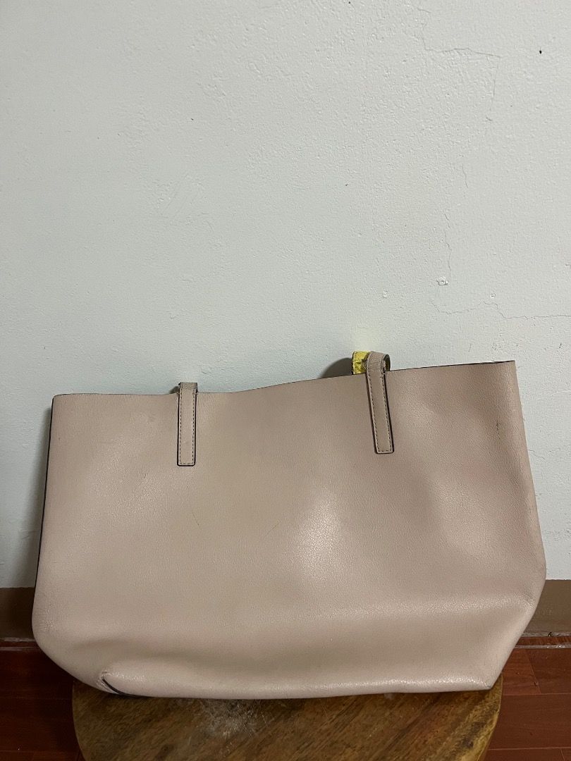 Kate Spade New York Tote Bag (Category: Tote Bags) located in Cabuyao City. Submitted by rdtrmt (Listing ID 1469404875, Image 2). Description: - Brand: Kate Spade (Original) - Pink leather tote bag with a vibrant yellow interior lining - Features double shoulder straps and a debossed silver logo on the front - Roomy everyday carryall style, perfect for daily use - Condition: Some wear on the strap edges but still in good condition.