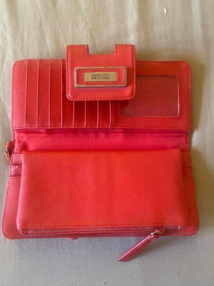Kenneth Cole Reaction Red Wristlet Wallet (Category: Wallets & Card holders) located in Muntinlupa City. Submitted by swiftowl.0cc8ab (Listing ID 1469451024, Image 2). Description: - Brand: Kenneth Cole Reaction - Color: Bright red with chic gold-tone hardware - Material: Textured faux leather - Barely used. bought it from Canada. - Interior: Multiple card slots, clear ID window, and cash compartments - Mode of Payment: GCash, BPI, or BDO - Shipp
