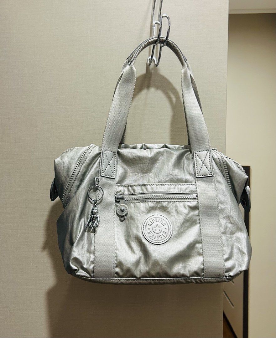Kipling 2 way Cross body / handbag (Category: Cross-body Bags) located in Quezon City. Submitted by melrose_place (Listing ID 1469519926, Image 1). Description: Kipling light metallic silver/gold hand held bag with Strap. Like new. Very nice. issue : inside pink stain #kiplingph .