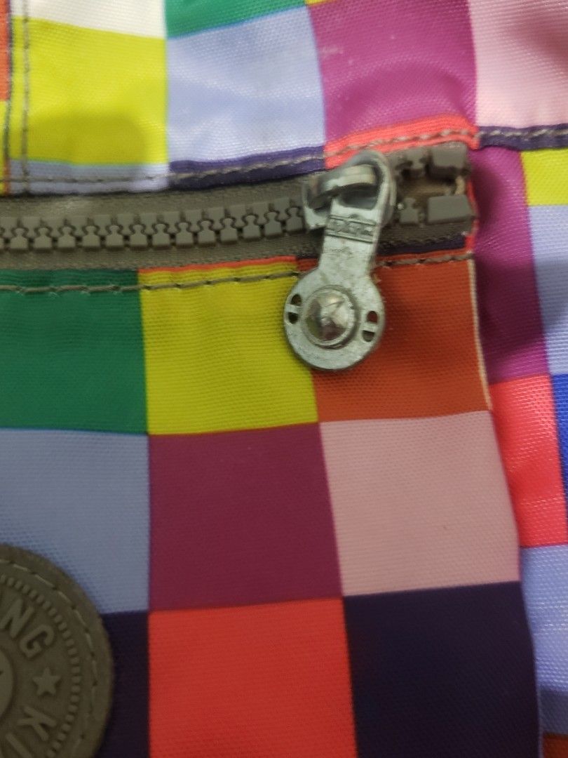 Kipling Colorful Pixel Mosaic Crossbody Bag (Category: Cross-body Bags) located in Manila. Submitted by declutteresque (Listing ID 1469474798, Image 3). Description: - Brand: Kipling - Design: Bright multicolored pixel/block pattern with iconic round logo patch - Material: Lightweight, easy-to-clean durable nylon - Compartments: Secure top zip main closure and handy front zip pocket - Strap: Adjustable dark grey canvas strap with stylish metallic