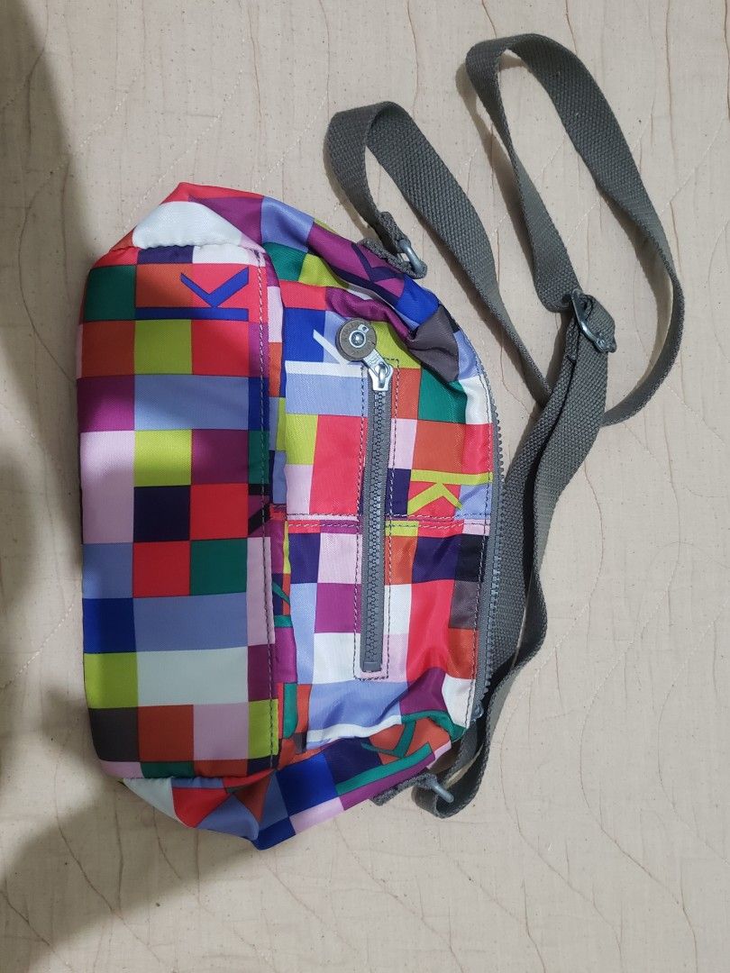 Kipling Colorful Pixel Mosaic Crossbody Bag (Category: Cross-body Bags) located in Manila. Submitted by declutteresque (Listing ID 1469474798, Image 2). Description: - Brand: Kipling - Design: Bright multicolored pixel/block pattern with iconic round logo patch - Material: Lightweight, easy-to-clean durable nylon - Compartments: Secure top zip main closure and handy front zip pocket - Strap: Adjustable dark grey canvas strap with stylish metallic