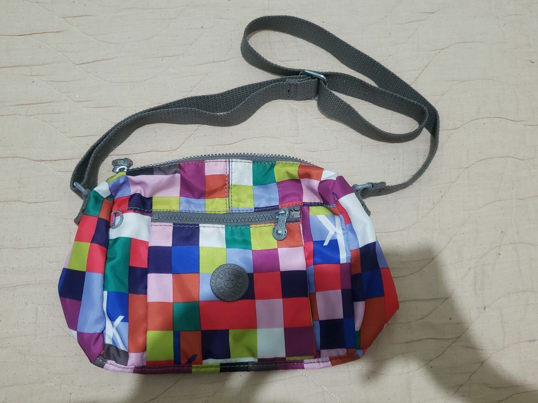 Kipling Colorful Pixel Mosaic Crossbody Bag (Category: Cross-body Bags) located in Manila. Submitted by declutteresque (Listing ID 1469474798, Image 1). Description: - Brand: Kipling - Design: Bright multicolored pixel/block pattern with iconic round logo patch - Material: Lightweight, easy-to-clean durable nylon - Compartments: Secure top zip main closure and handy front zip pocket - Strap: Adjustable dark grey canvas strap with stylish metallic