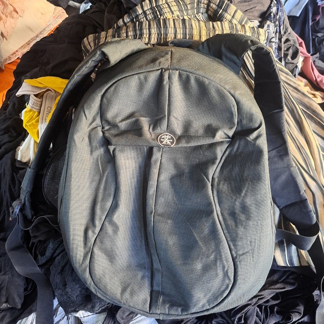 Krumpler Black Backpack with Multiple Compartments (Category: Backpacks) located in Manila. Submitted by warmphoenix_5fc5b2 (Listing ID 1469486944, Image 1). Description: - Brand: Krumpler - Color: Classic dark gray - Material: Sturdy, durable canvas - Design: Wide-opening main compartment for easy access - Organization: Lots of internal mesh pockets for gear - Comfort: Padded back panel - Details: Custom branded zipper pulls on all closures - Co
