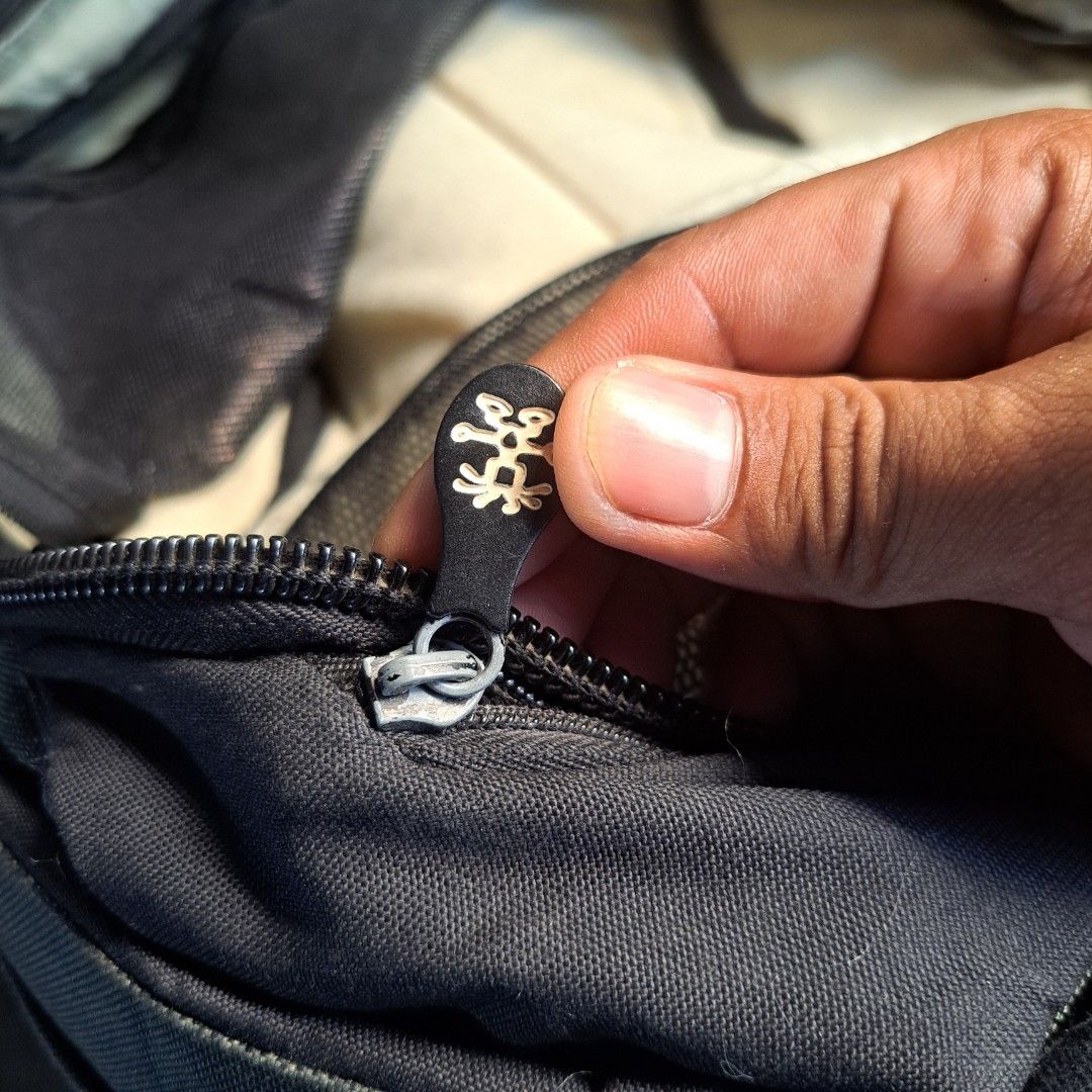 Krumpler Black Backpack with Multiple Compartments (Category: Backpacks) located in Manila. Submitted by warmphoenix_5fc5b2 (Listing ID 1469486944, Image 3). Description: - Brand: Krumpler - Color: Classic dark gray - Material: Sturdy, durable canvas - Design: Wide-opening main compartment for easy access - Organization: Lots of internal mesh pockets for gear - Comfort: Padded back panel - Details: Custom branded zipper pulls on all closures - Co