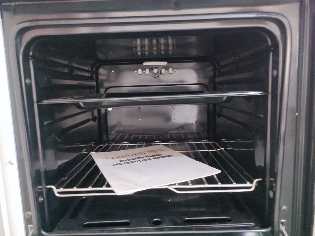 La Germania SL100 10W Electric Oven (Category: Ovens & Toasters) located in Bulacan. Submitted by Nekomimi12 (Listing ID 1469454633, Image 2). Description: - Brand: La Germania - Model: SL100 10W - Color: White - Control: Right-side rotary knob with temperature conversion chart - Door: Glass door with protective plastic on the handle - Interior: Clean black enamel cavity - Inclusions: Wire rack, baking tray, and instruction manual - Condition: Ex