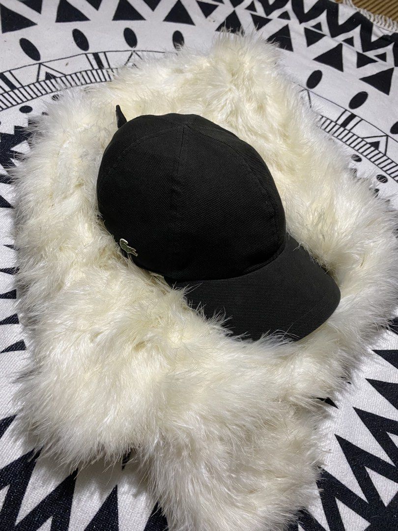 Lacoste Black Cap (Category: Caps & Hats) located in Badiangan. Submitted by iralorana.thrift (Listing ID 1469419329, Image 1). Description: - Brand: Lacoste - Color: Classic Black - Design: Structured with a curved brim - Details: Iconic embroidered green crocodile on the side and Lacoste lettering on the back strap - Fit: Adjustable strap closure for a custom fit - Condition: Clean fabric with minimal signs of wear.