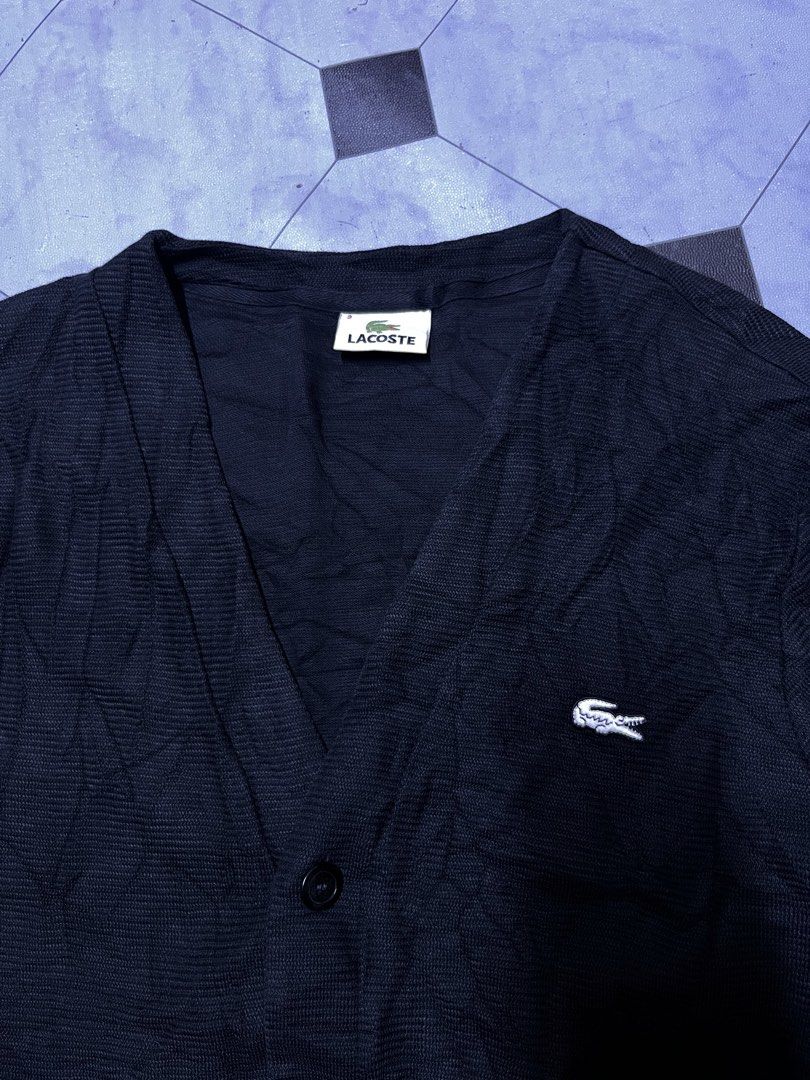 Lacoste Black Cardigan Size 3 (Category: Coats, Jackets and Outerwear) located in Manila. Submitted by ba_thrifted (Listing ID 1469525819, Image 2). Description: Black Lacoste cardigan with button-up front and front pockets. Ribbed cuffs and hem. Size 3 tag on the collar. Embroidered crocodile logo on the chest. Classic v-neck style, lightweight knit material. Great layering piece..