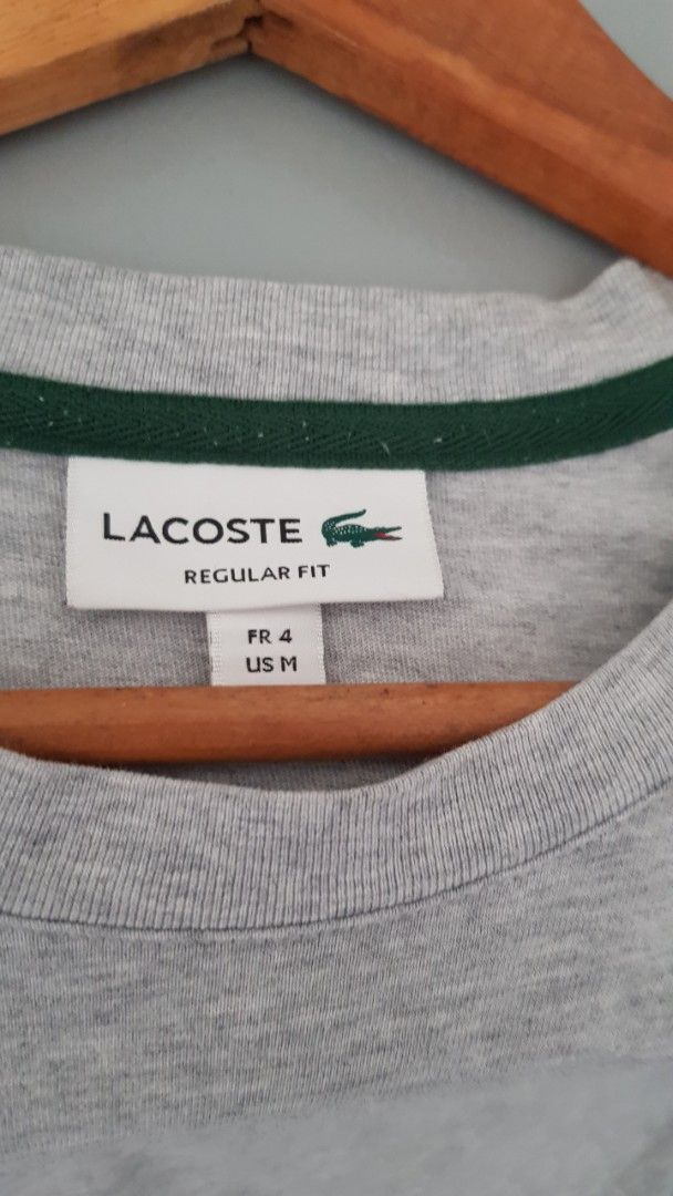 Lacoste Regular Fit Grey T-Shirt Size M (Category: Tshirts & Polo Shirts ) located in Manila. Submitted by nice430 (Listing ID 1469448844, Image 2). Description: - Brand: Lacoste - Color: Grey - Size: Medium (FR 4) - Material: 100% Cotton - Fit: Regular fit with crew neck and short sleeves - Details: Embroidered crocodile logo and wordmark on chest, plus small embroidered crocodile near bottom hem - Style Number: TH9665 - Origin: Made in Mauritiu