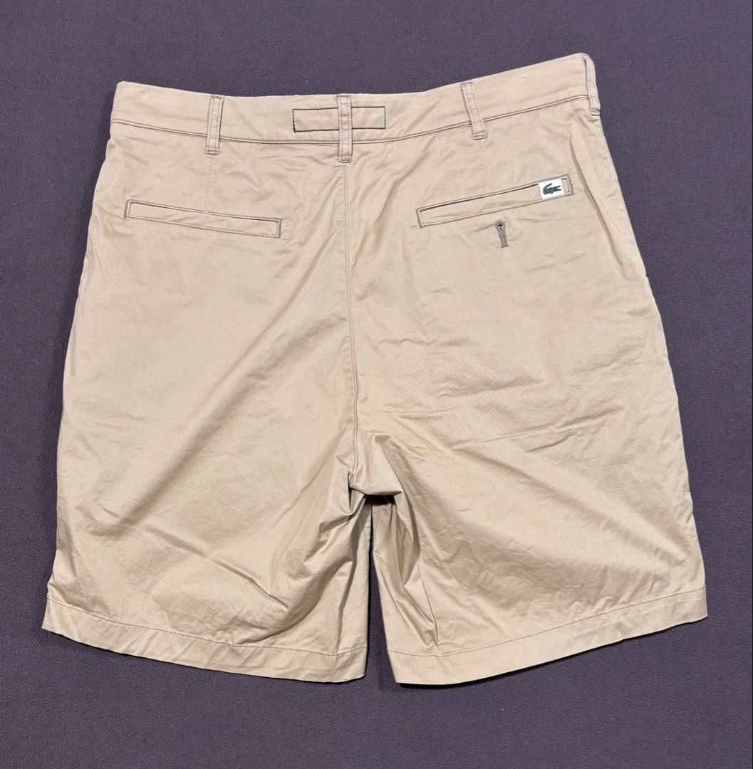 Lacoste Regular Fit Khaki Shorts (Category: Shorts) located in Mabalacat. Submitted by _limitlessfashion (Listing ID 1469420659, Image 2). Description: - Brand: Lacoste - Style: Regular fit khaki shorts - Size: US 32 / FR 40 - Length 19 - Hem 11.2 - No major issue - Details: Button closure with zip fly, front hand pockets, dual rear pockets, branded buttons, and inner waistband taping - Branding: Small embroidered crocodile logo above the right b
