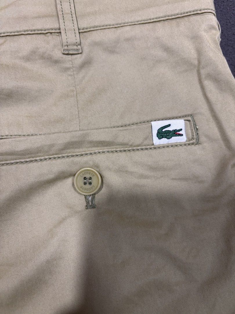 Lacoste Regular Fit Khaki Shorts (Category: Shorts) located in Mabalacat. Submitted by _limitlessfashion (Listing ID 1469420659, Image 3). Description: - Brand: Lacoste - Style: Regular fit khaki shorts - Size: US 32 / FR 40 - Length 19 - Hem 11.2 - No major issue - Details: Button closure with zip fly, front hand pockets, dual rear pockets, branded buttons, and inner waistband taping - Branding: Small embroidered crocodile logo above the right b