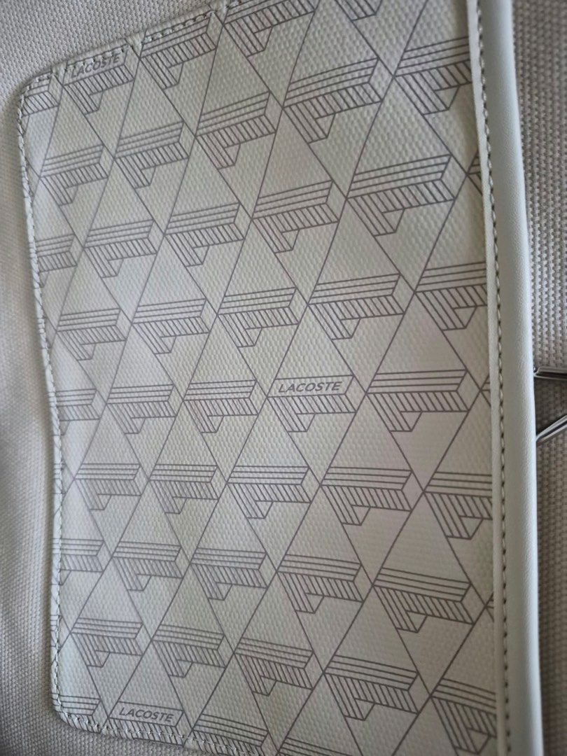 Lacoste Tote Bag NF4344ZE with Pouch (Category: Tote Bags) located in Manila. Submitted by freestone_f18729 (Listing ID 1469569938, Image 3). Description: - Color/Pattern: White with all-over geometric monogram print - Includes: Matching zippered pouch and white dust bag - Design: Double shoulder handles, open top interior, unlined canvas fabric - Origin: Made in Cambodia - Style Code: S2625 PK NF4344ZE - Condition: Brand new and well-maintained 